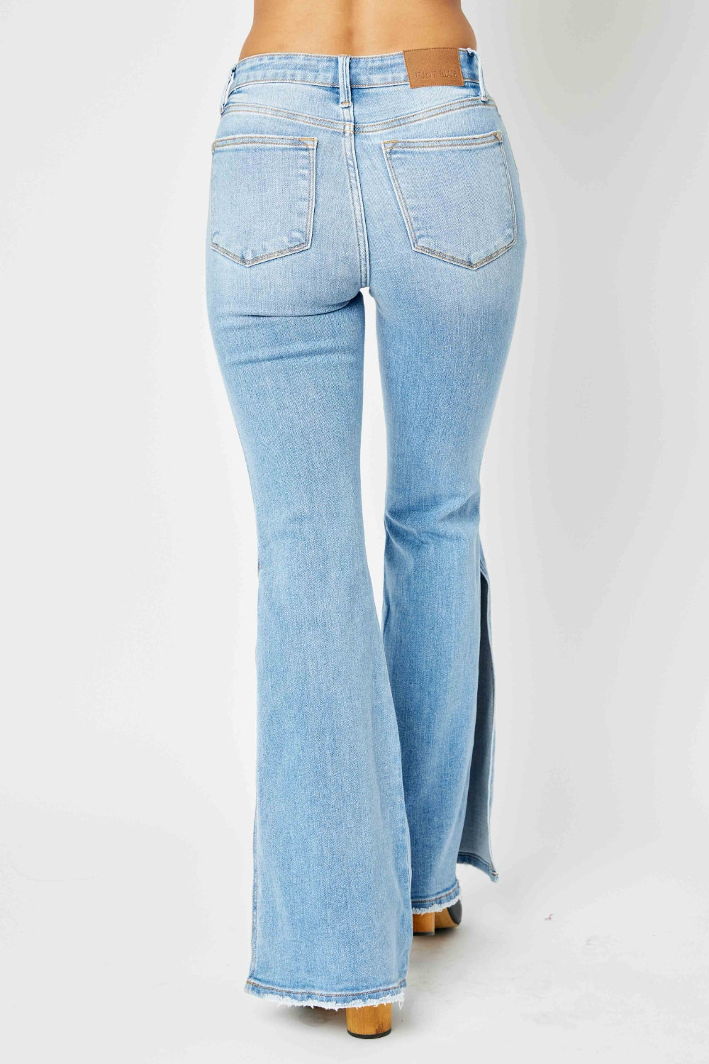 Judy Blue Full Size Mid Rise Raw Hem Slit Flare Jeans Judy Blue Full Size Mid Rise Raw Hem Slit Flare Jeans - TopFashionHQ
