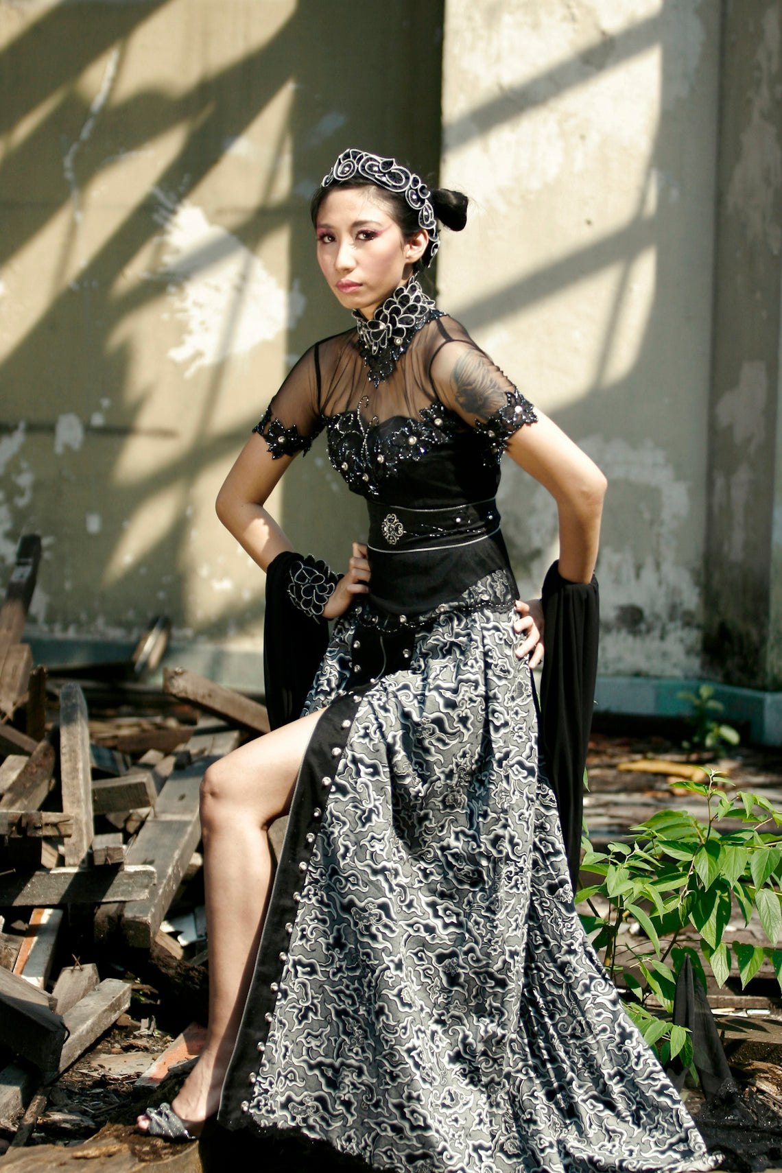 a woman in a black and white dress sitting on a chair