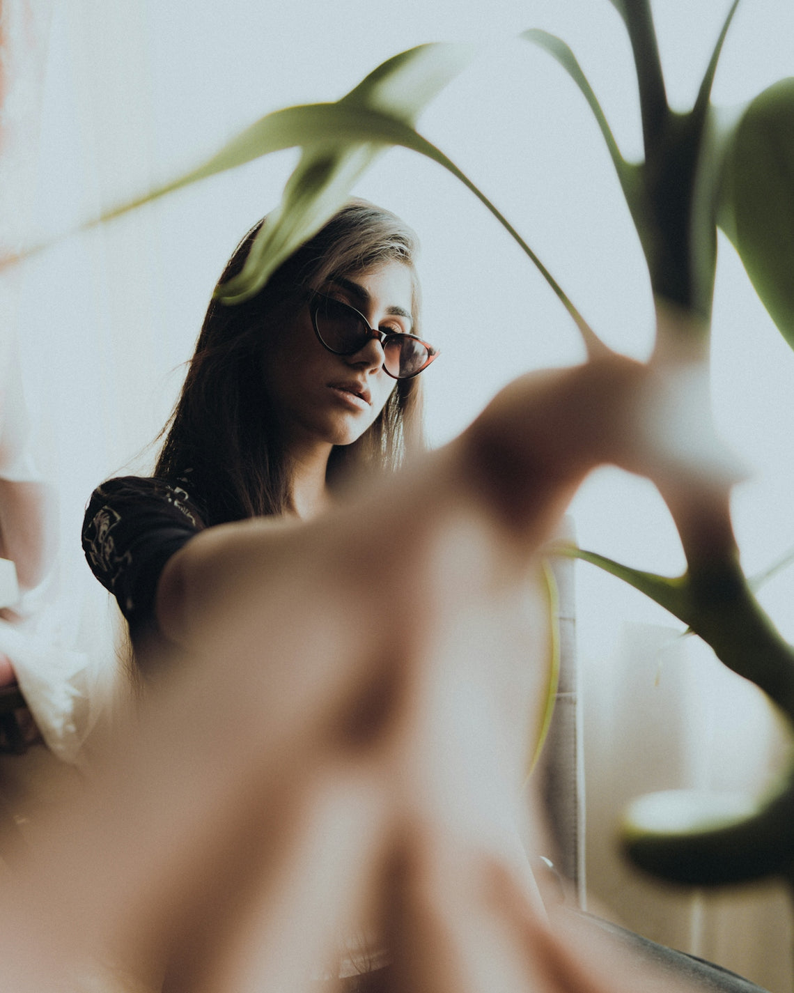 a woman wearing sunglasses looking at her cell phone