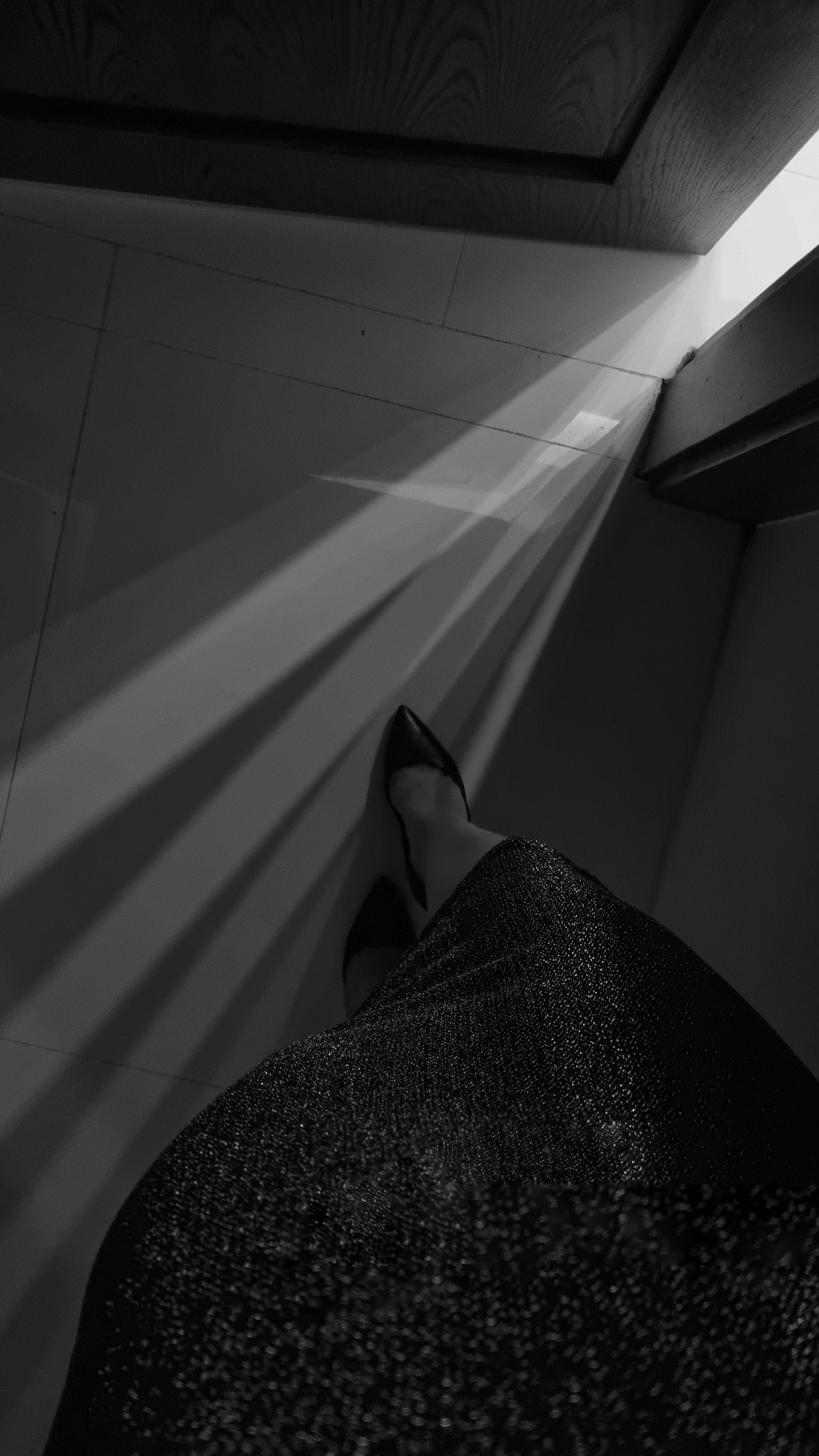 a black and white photo of a woman's shoes