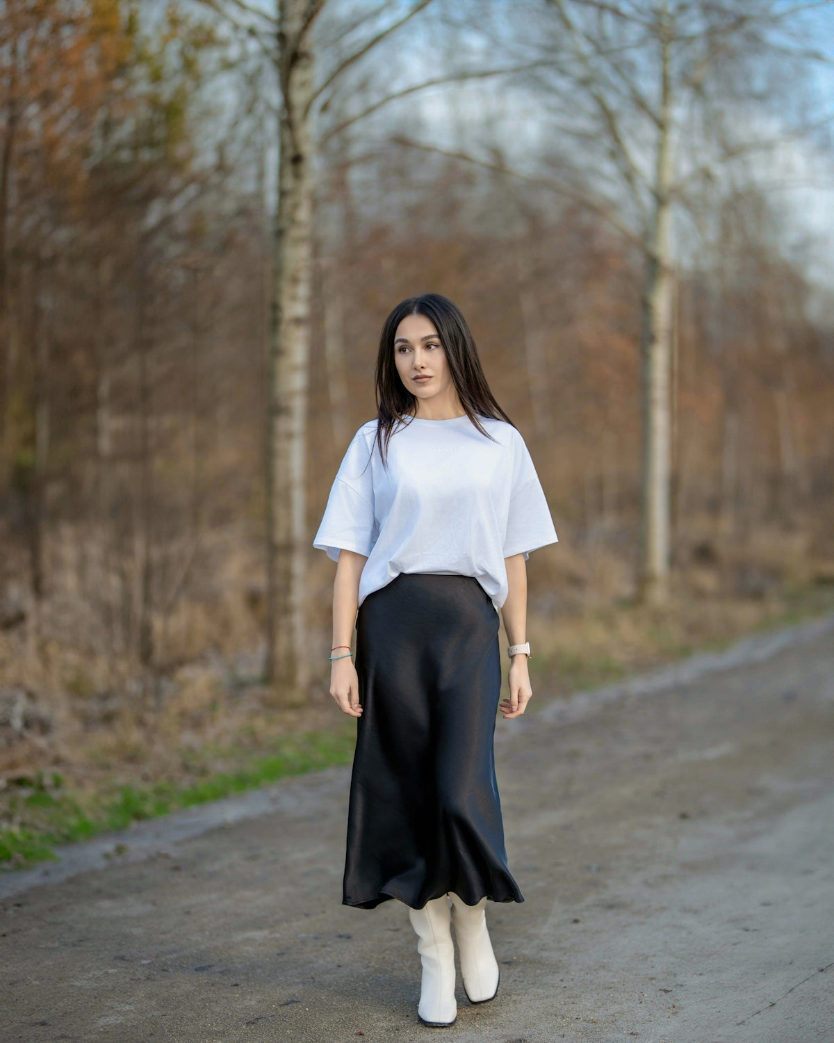 a woman in a white shirt and black skirt