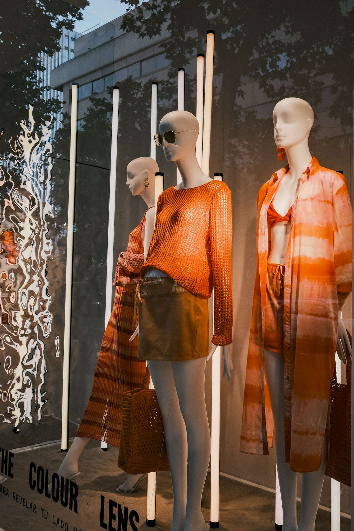 three mannequins dressed in orange and orange clothing