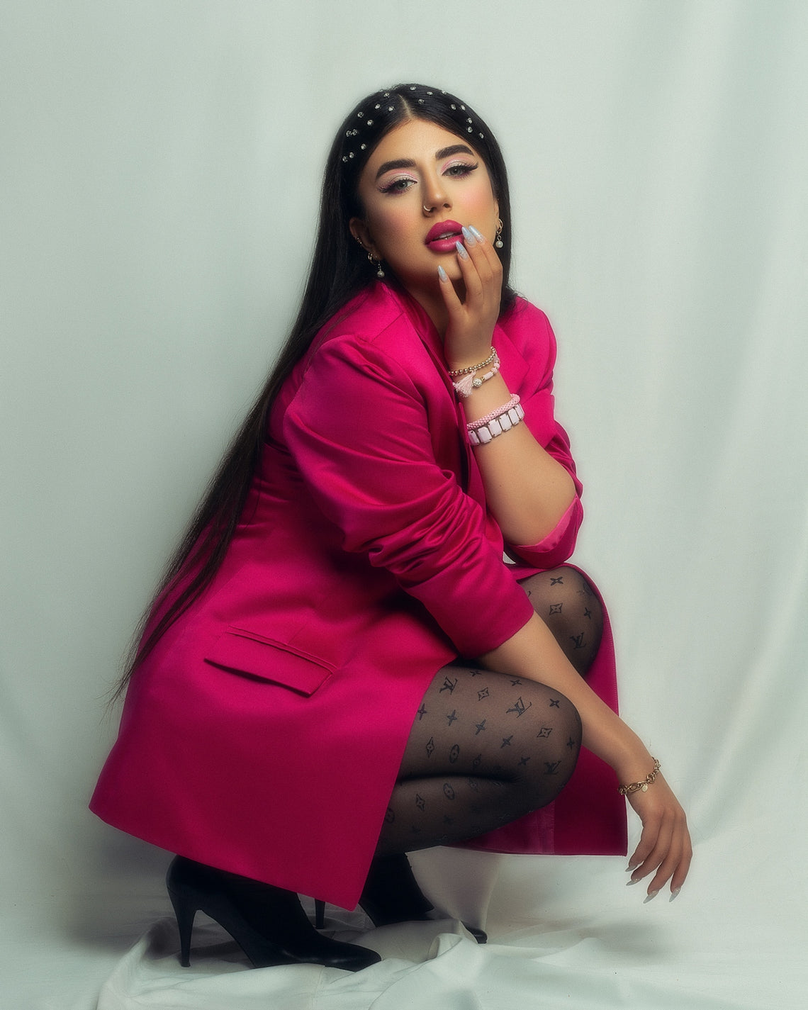 A woman in a pink coat is posing for a picture