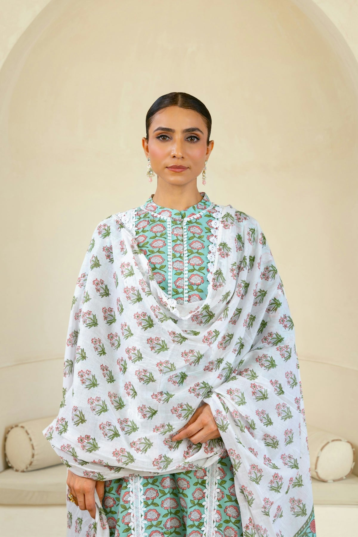 A woman wearing a white and green dress