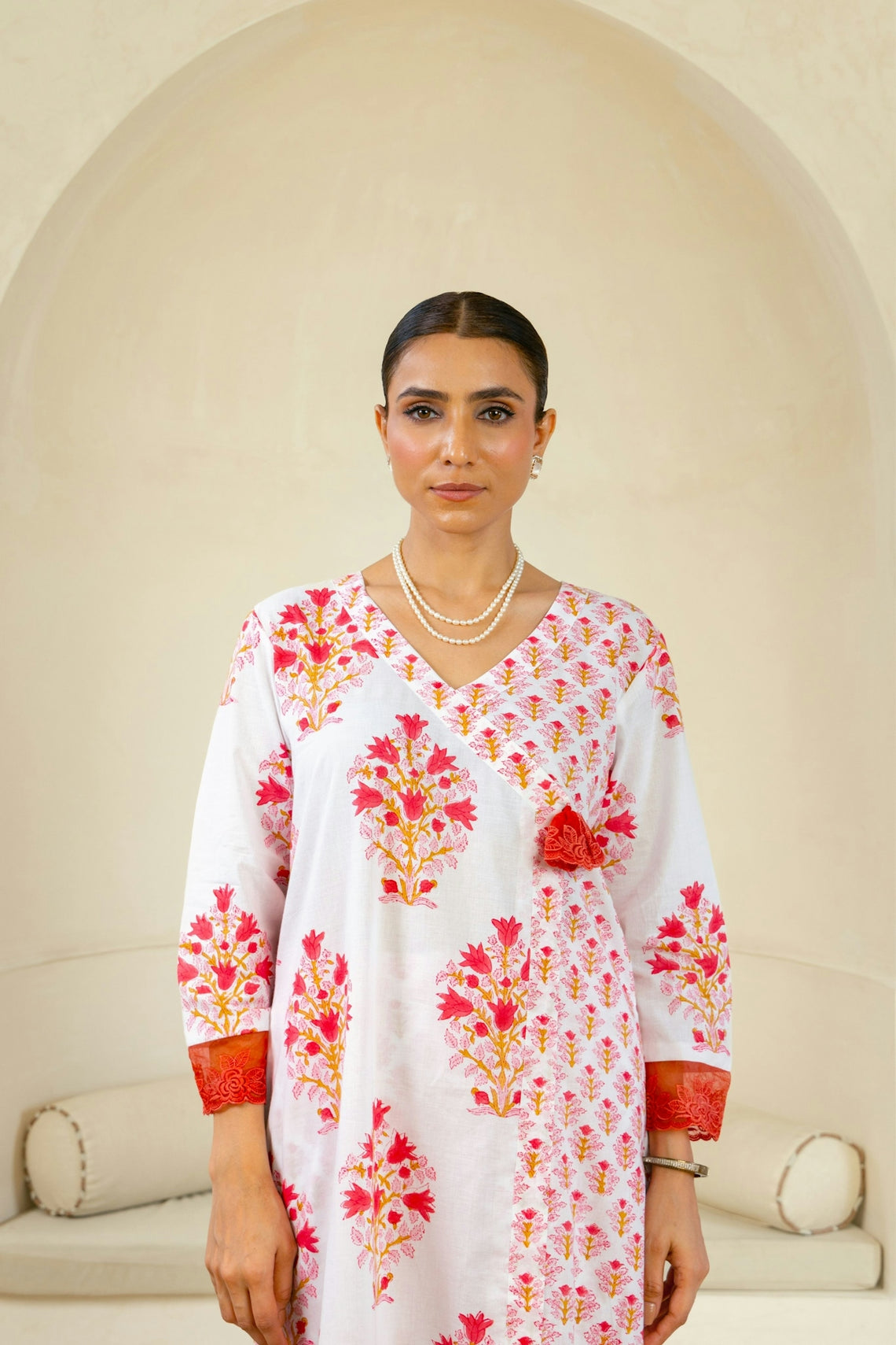 A woman standing in front of a white couch