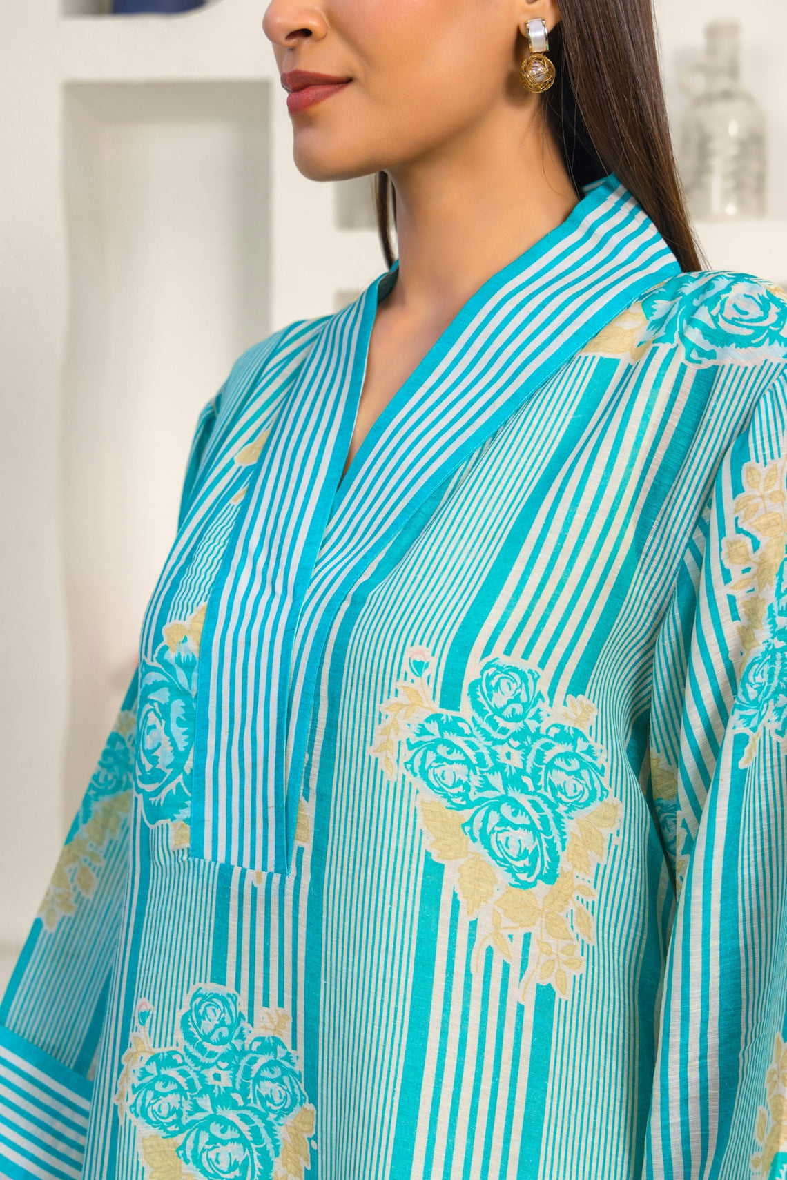 A woman wearing a blue and gold dress