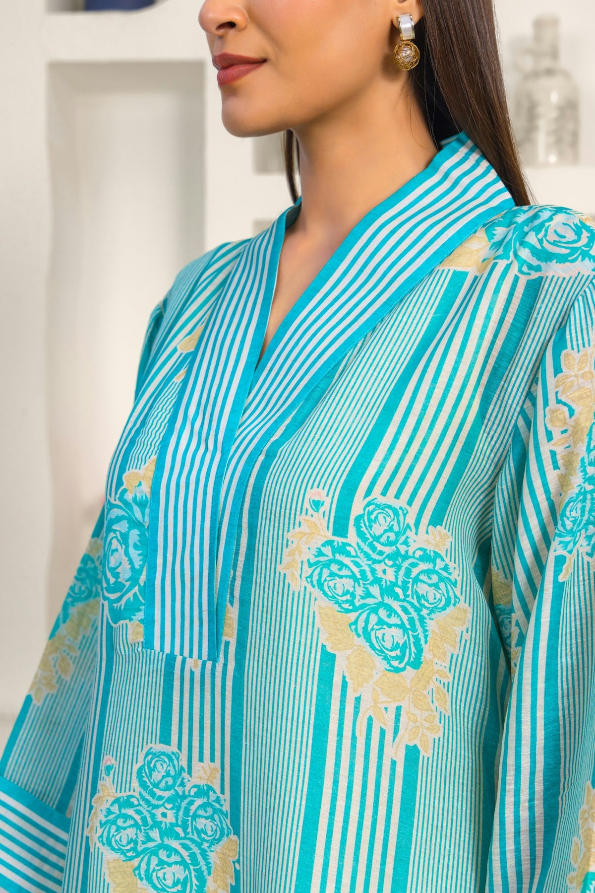 A woman wearing a blue and gold dress