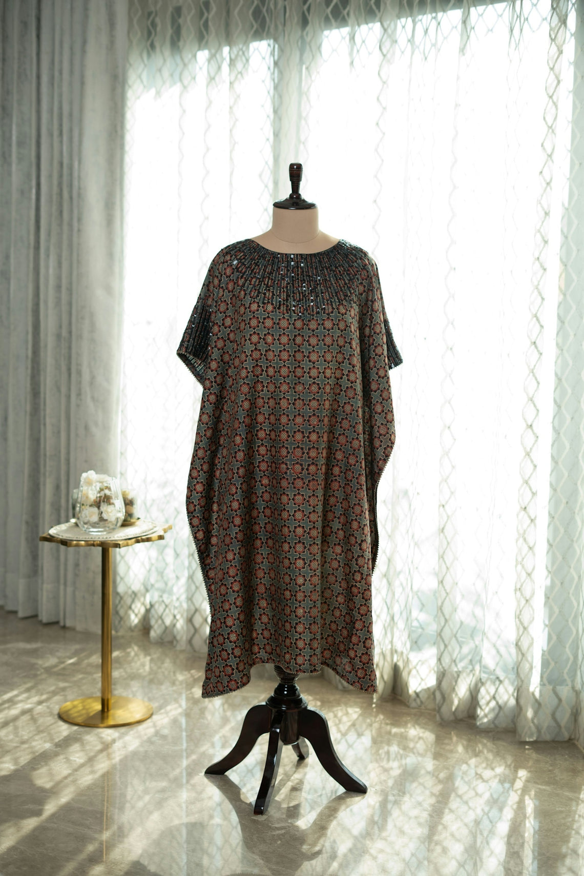 A dress on a mannequin in front of a window