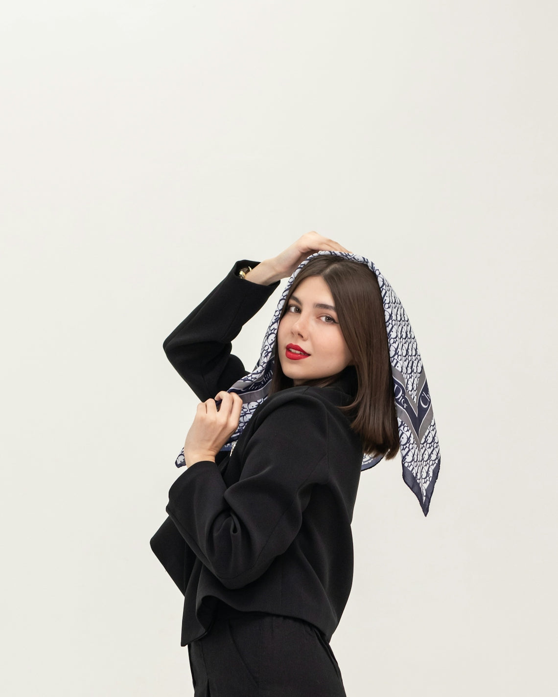 Woman in black jacket with patterned scarf