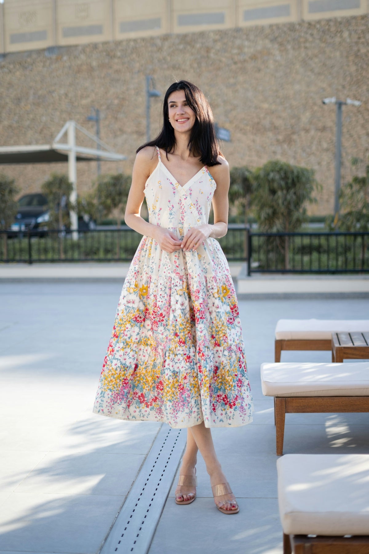 Woman in a floral sundress standing outdoors