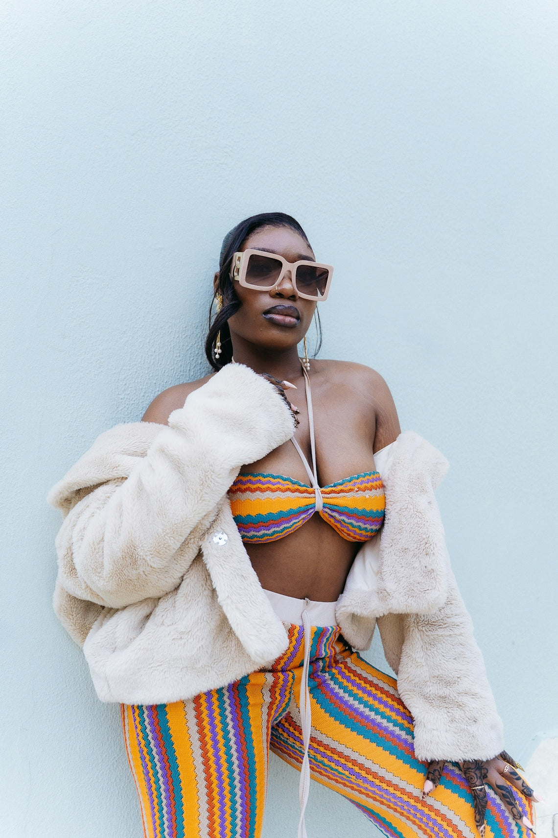 Woman in colorful outfit and fur coat