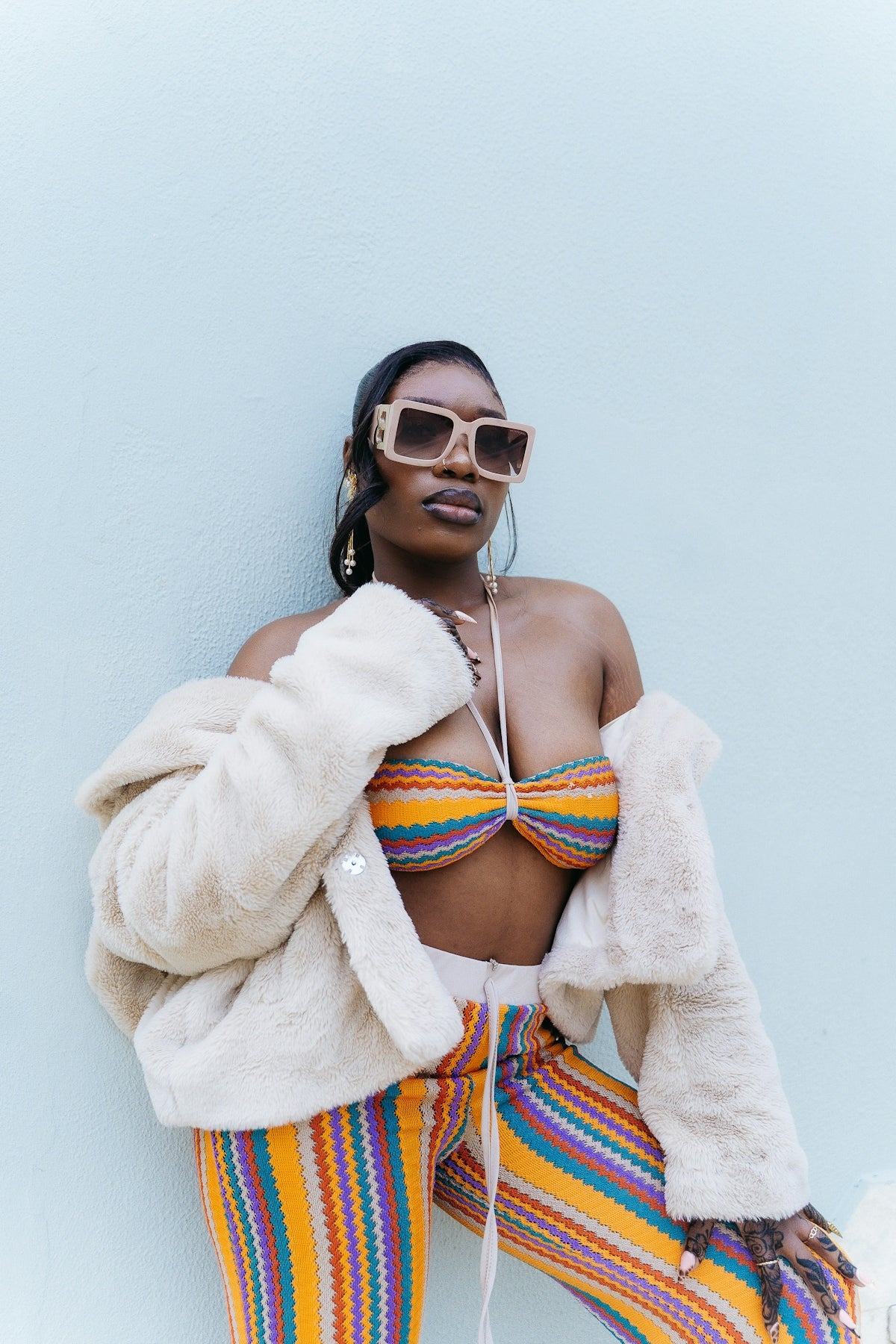 Woman in colorful outfit and fur coat