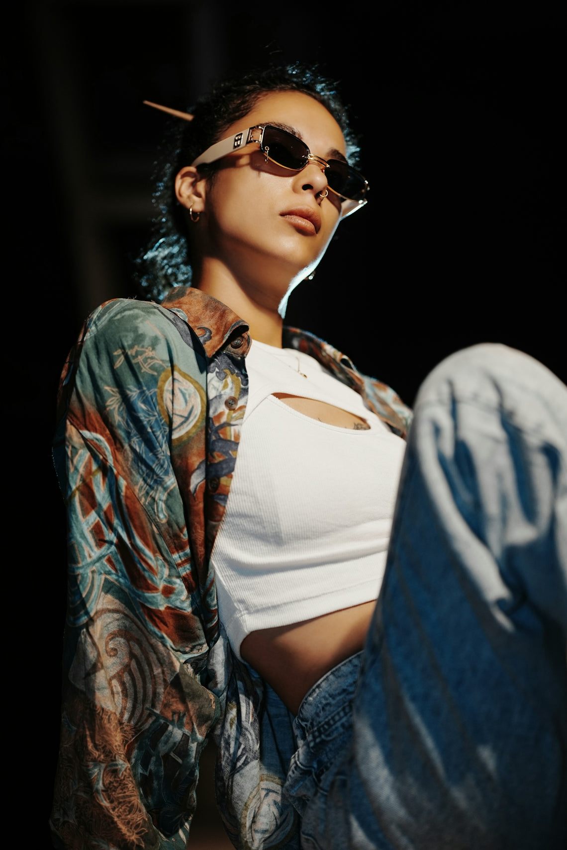 Young woman wearing sunglasses and patterned shirt